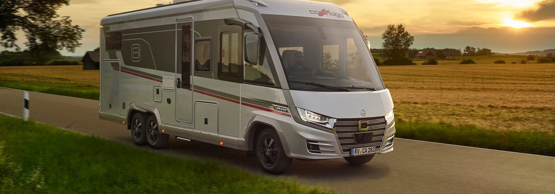 Carthago Wohnmobil e-line auf der Straße im Sonnenuntergang